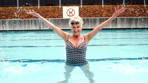 Smiling senior woman enjoying in pool