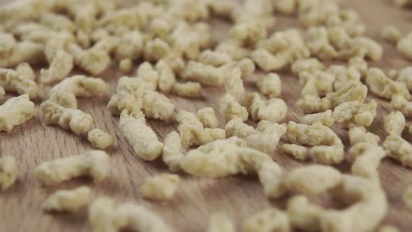 Soy flakes are spilled onto the board in slow motion