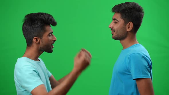 Side View Two Positive Middle Eastern Men Gesturing Highfive on Green Screen Smiling and Hugging