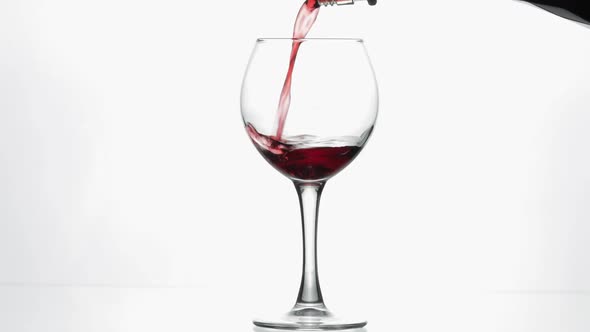 Rose Wine. Red Wine Pour in Wine Glass Over White Background