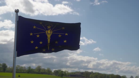 Indiana Flag on a Flagpole Waving in the Wind in the Sky
