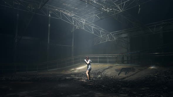 4K Asian woman boxer practicing boxing exercise punching the air in abandoned building.