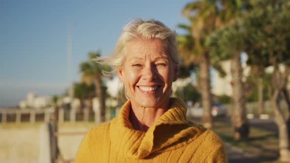 Front view of senior woman alongside beach