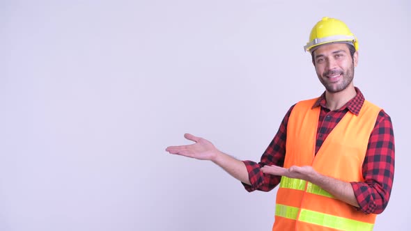 Happy Bearded Persian Man Construction Worker Showing Something