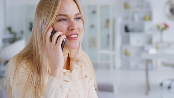 Young woman talking on the phone at home office