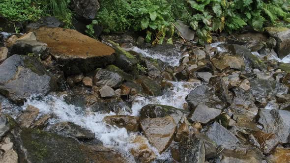 Wild Mountain River Flowing with Stone Boulders and Stone Rapids. Slow Motion