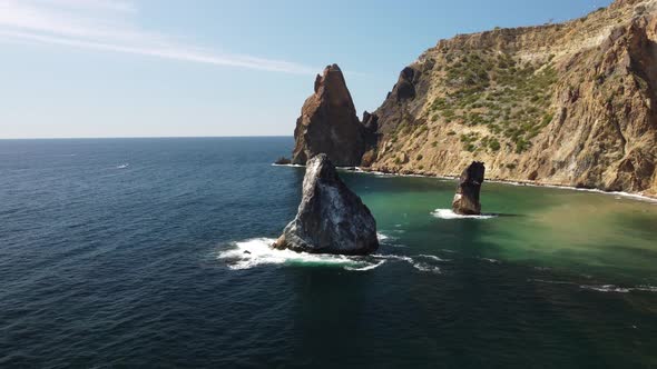 Aerial View From Above on Calm Azure Sea and Volcanic Rocky Shores