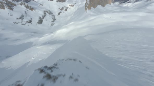 Aerial View FPV Drone Extreme Flying Over Thin Narrow Rock Winter Mountain Landscape