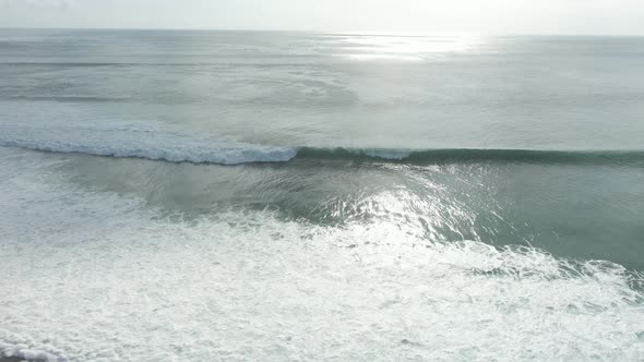 Aerial View Of Ocean Waves Crashing On Shore In Indonesia