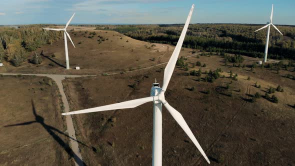 Wind Towers Working on a Big Field. Renewable Energy Concept.