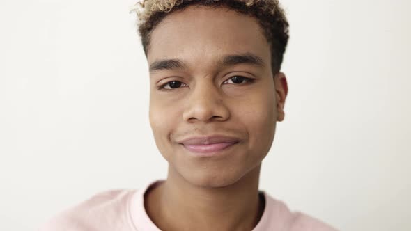 Cheerful Portrait of Young African American Man Smiling at Camera