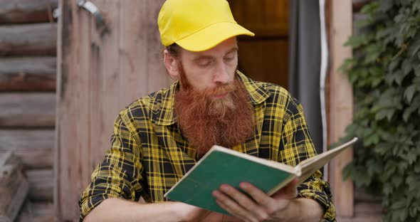 A Farmer with a Red Beard Reads a Book