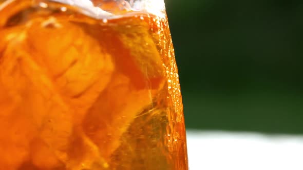 Refreshing orange drink in the sun - 180fps