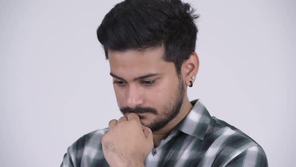 Portrait of Young Serious Bearded Indian Man Thinking