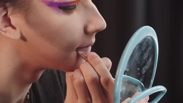 Drag Artist  Young Man Applying a Lip Pencil Lower His Lips