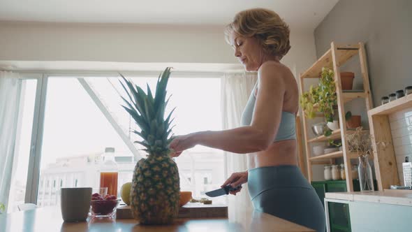 Woman preparing fruits and juices for breakfast