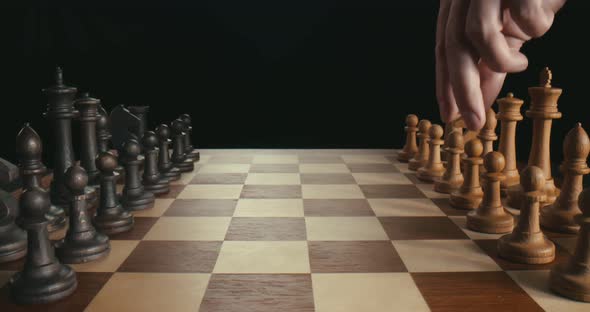 Close Up of Male Players Making First Moves with Wooden Pawns Playing Chess Game