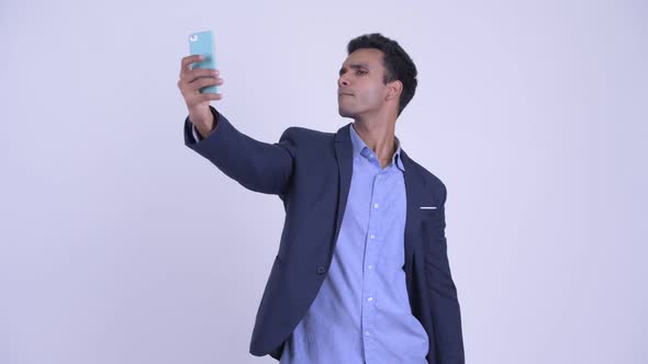 Happy Young Indian Businessman Taking Selfie