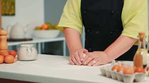 Woman Hands Kneading Dough on Table