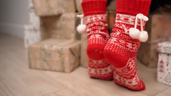 Female Legs in Red New Year's Socks are Suitable for Decorating a Christmas Tree
