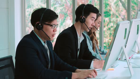 Business People Wearing Headset Working in Office