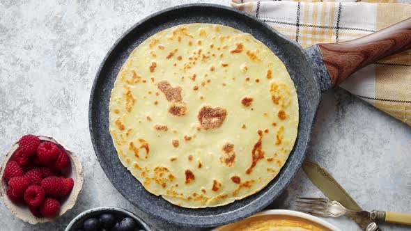 Delicious Pancakes on Stone Frying Pan. Placed on Table with Various Ingredients