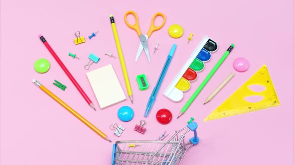 School Supplies on Pink Background in Shopping Cart