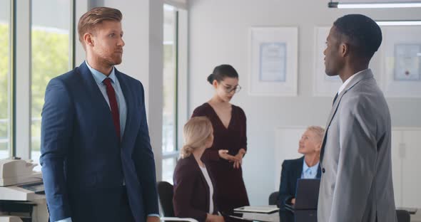 Business Partners Shaking Hands in Modern Workplace Office