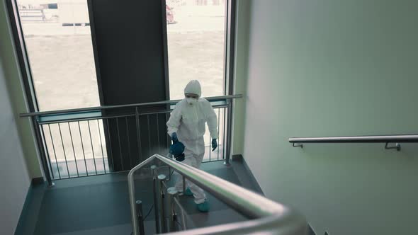 Top view of sanitation worker disinfecting the staircase. Shot with RED helium camera in 8K.