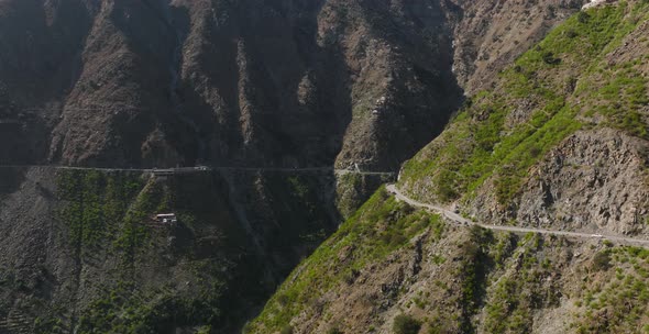 Aerial View Of Winding Road On Mountainside In Swat Valley. Dolly Forward Establishing Shot