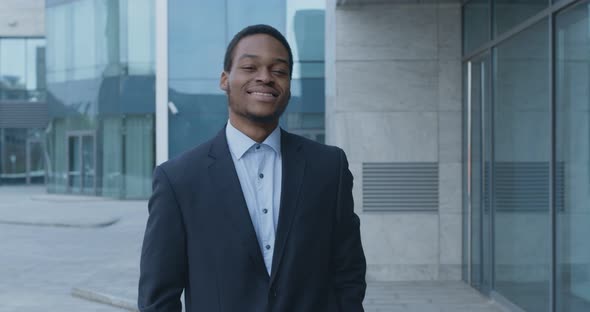 Successful African American Businessman in Suit Walking Near Corporate Office Building, Slow Motion