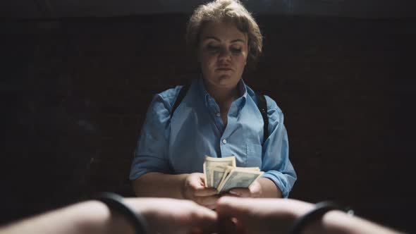 Close Up of Suspect Hands in Handcuffs Giving Money To Female Police Officer As Bribe