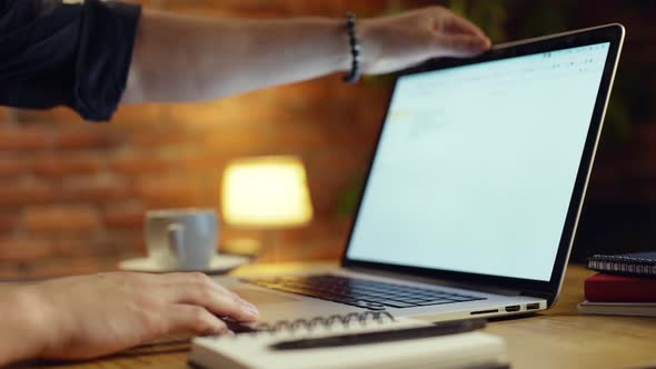 Close Up of Businessman Working with Laptop in Office at Night