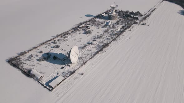 Aerial View of the Space Communication Station in Snow Covered Field at Sunny Winter Day Drone