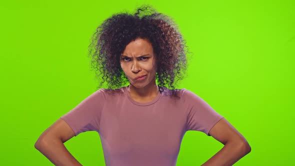 Offend African American Woman in Pink T-shirt Poses on Green