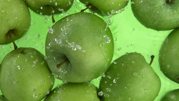 Super Slow Motion Shot of Fresh Green Apple Falling and Splashing Into Water at 1000Fps