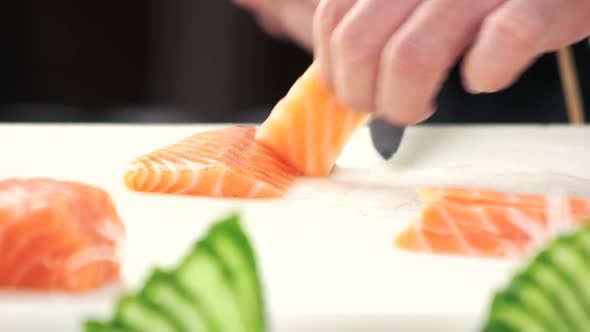 Hands Slicing Fish Close Up