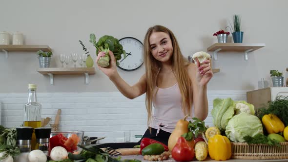 Girl Recommending Eating Raw Vegetable Food. Showing Broccoli and Cauliflower. Weight Loss, Diet