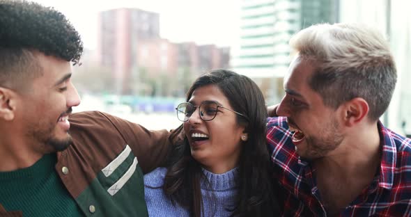 Young diverse friends smiling on camera outdoor