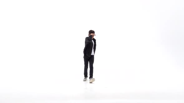 Little Boy Is Dancing a Modern Dance on the White Background in Black Leather Jackets and Jeans