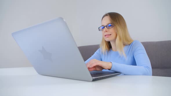 Freelancer woman working on notebook computer at home in 4k video