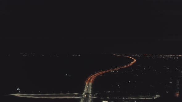 Aerial view of Night highway with orange and white lanterns and lightning 14