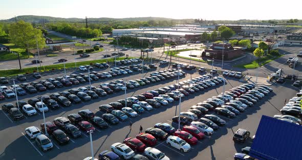 CarMax dealership parking lot. Used cars for sale. Aerial view of full parking lot during spring sun