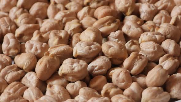 Macro close up shot of raw light chickpeas rotating. Chana. Static, top view