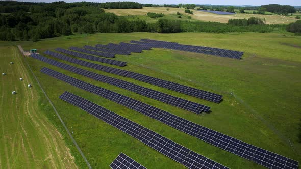 Solar panel arrays on farmland. Aerial shot of green energy.