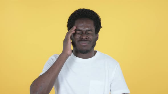 African Man with Headache, Yellow Background