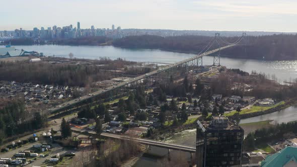 Flying Towards Bustling Road Of Lions Gate Bridge At Stanley Park In Vancouver BC, Canada. Aerial Sh