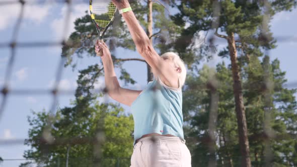 Successful Joyful Happy Mature Woman Won the Tennis Tournament. The Old Lady Jumping Raising Hands