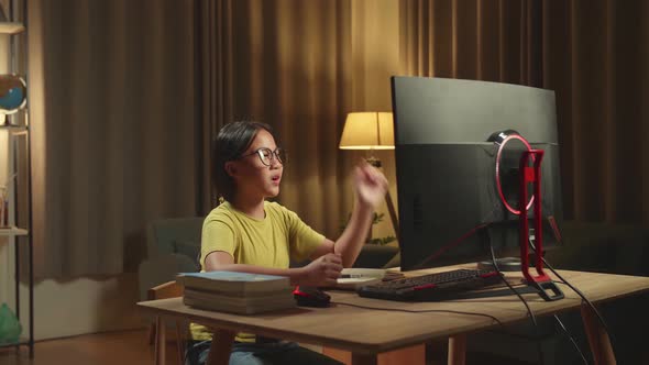 Asian Girl Learning Online From Home, Raising Hand Distance Learning Online While Using Computer