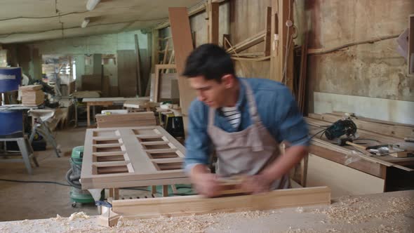 Carpenter Shaping Plank with Hand Plane